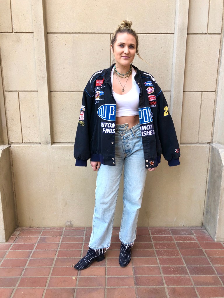 Hailey wearing a thrifted jacket, cropped halter from Brandy Melville, ReVice jeans, and studded boots from Asos